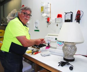 Brett at work repairing a sewing machine at BCS Electrical.