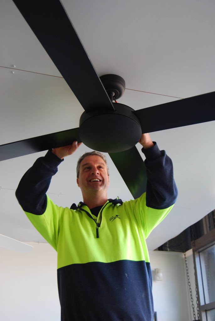 Mark from BCS Electrical working on a ceiling fan